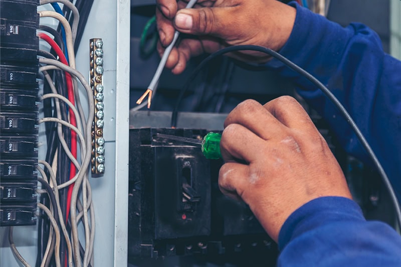 Upgrade Your Outdated Electrical Panel. An electrician working on an electrical panel.